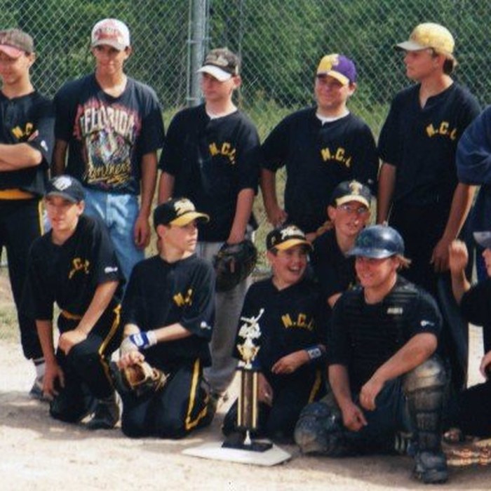 Youth baseball team with trophy